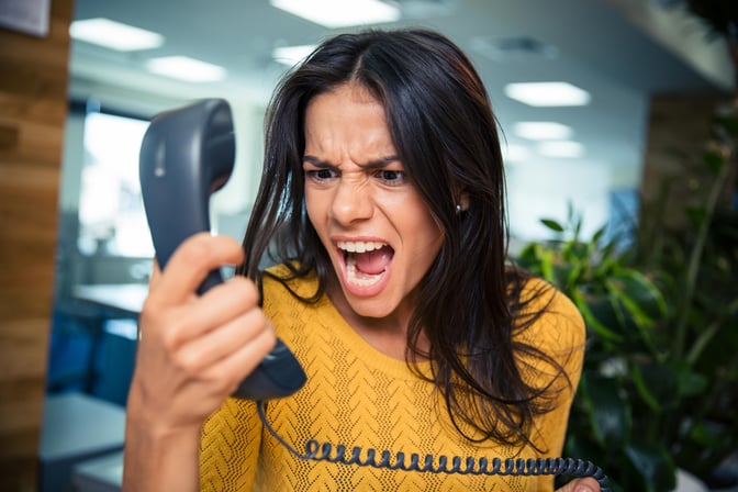 Angry businesswoman shouting on phone in office-2